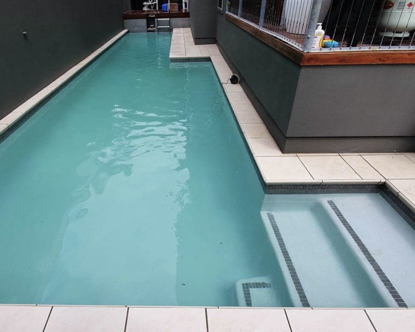 Pool after full renovation — sparkling blue with new coping
