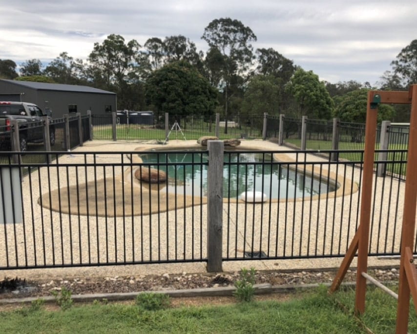Pool before renovation — green water and old surrounds