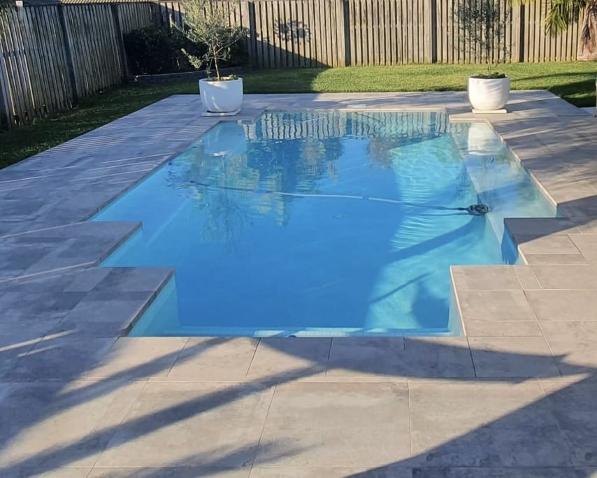 Pool after complete renovation — new travertine coping